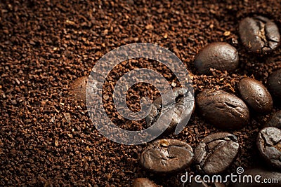 Closeup of mixed heap of roasted coffee beans and ground coffee with copy space Stock Photo