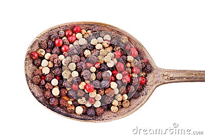 Closeup mixed peppercorns in silver rustic spoon. Isolated on white background with work path. Stock Photo