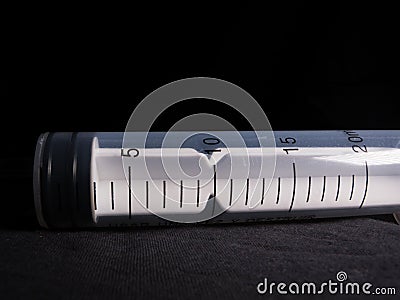 Closeup of a 20 ml syringe- Medical equipment studio shot with black background Stock Photo