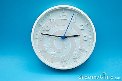 modern analog clock on blue background Stock Photo