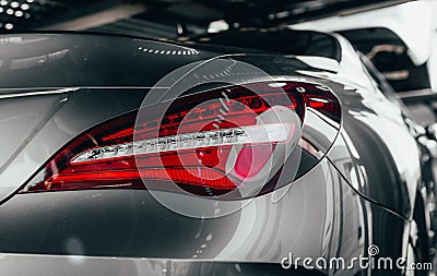 Closeup modern luxury grayBack lights headlight and head lamp of powerful beast sport car . Dealership office showroom for sale ba Stock Photo