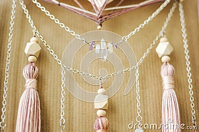 Closeup modern mandala with quartz crystals, amethyst, moonstone, tassels and chain on craft paper background Stock Photo