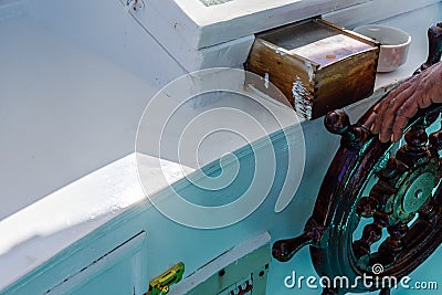 Closeup of the modern yacht steering wheel and captain hand Stock Photo