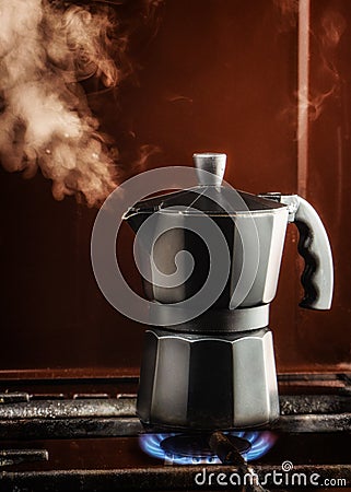 Closeup of Moka coffee pot on a gas stove Boils and lets off steam Stock Photo