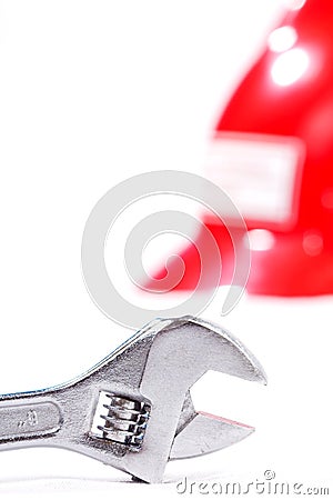 Closeup of monkey wrench with safety helmet. Stock Photo