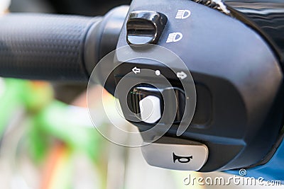 Closeup the motorcycle horn and switch off/on lighting on e-bike handlebar Stock Photo