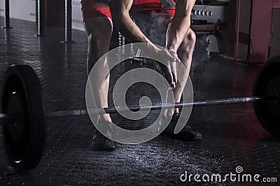 Closeup of muscular athlete clapping hands before barbell worko Stock Photo