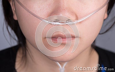 Nasal cannula for oxygen delivery on a woman patient Stock Photo