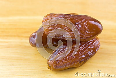 Closeup of natural dried dates fruit on wooden background Stock Photo