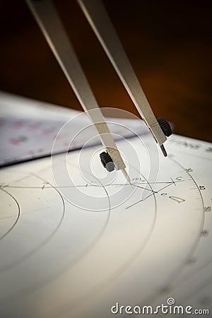 Closeup of a navigator's radar plotting chart with a triangle and compass divider Stock Photo