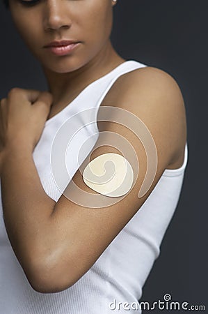 Closeup Of Nicotine Patch On Female's Arm Stock Photo