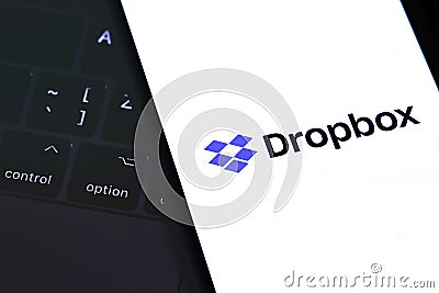 Notebook and smartphone with Dropbox logo Editorial Stock Photo