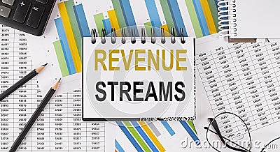 Closeup a notebook with text REVENUE STREAMS , business concept image on chart background Stock Photo
