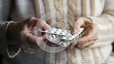 Closeup of old female hands holding pills Stock Photo