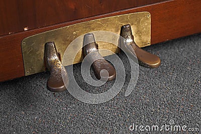 Closeup of old rusty piano pedals under the lights Stock Photo