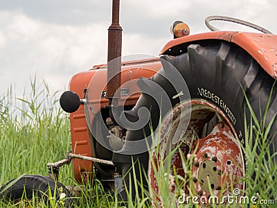 Closeup of old rusty traktor in field Stock Photo