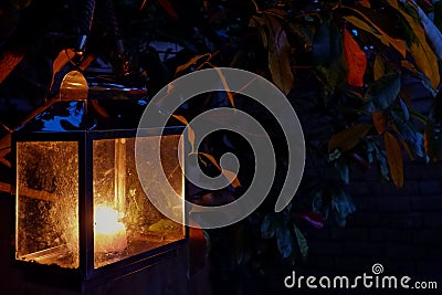 Closeup of an old street lantern glowing in the dark Stock Photo