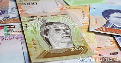 Closeup of old Venezuela central bank Bolivar currency banknotes with indigenous people (focus on center Stock Photo