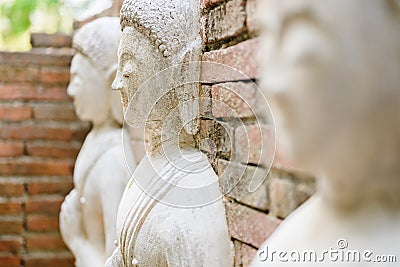 Buddha's disciples statue on the ruined brick pagoda Stock Photo