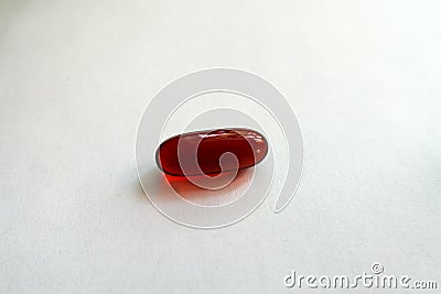 Closeup of one red softgel capsule of krill oil Stock Photo