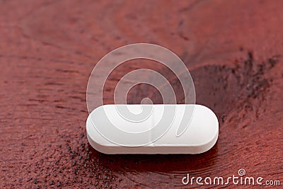 Closeup of one white pills Stock Photo