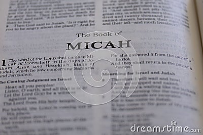 Closeup of an open page of the book of micah with partly blurred text Stock Photo