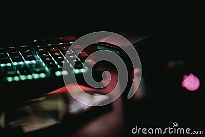 Closeup of a part of a glowing keyboard in the darkness. Stock Photo