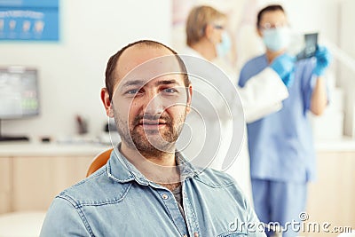 Closeup of patient man looking into camera waiting for doctors to start stomatology surgery Stock Photo