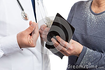 Closeup of patient putting money inside wallet and corrupt medic Stock Photo
