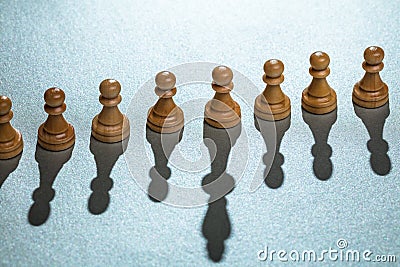 Pawn Chess Pieces With One Having Long Shadow Stock Photo