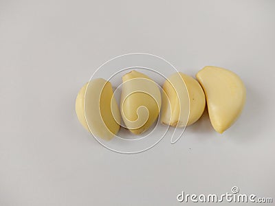 Closeup peeled garlic Allium sativum on a white background Stock Photo