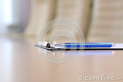 Closeup pen on table in empty corporate conference room before business meeting Stock Photo