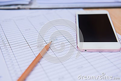 Closeup pencil with finance business sheet and phone . Business concept. Stock Photo