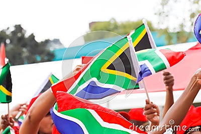 Closeup of the people holding the flags of South Africa. Stock Photo
