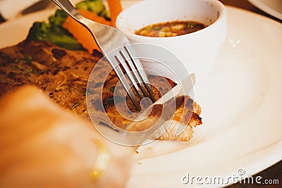 Closeup people `s hands eating steak with happy. Stock Photo