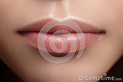 Closeup perfect natural lip makeup. Beautiful plump full lips on female face. Clean skin, fresh make-up. Spa tender lips Stock Photo