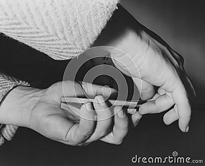 Closeup of person cutting cards Stock Photo