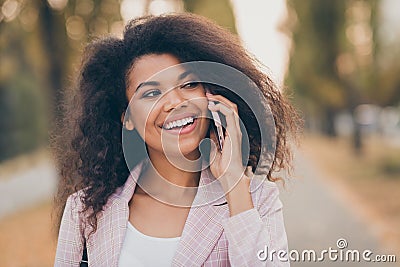 Closeup photo of amazing pretty dark skin lady spending time walk park after university lectures hold telephone speak Stock Photo