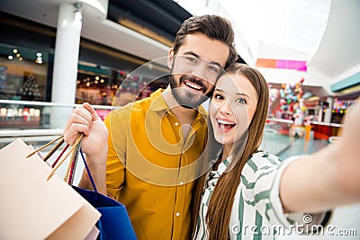Closeup photo of attractive funny lady handsome guy couple visit shopping store mall together carry many bags packs Stock Photo