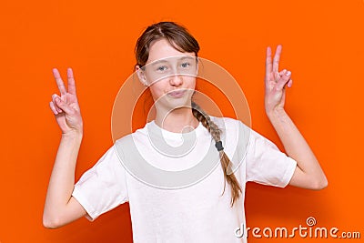 Closeup photo of beautiful little braided hair girl arms showing v-sign symbol hi friends good mood wear white t-shirt Stock Photo