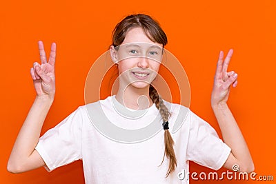Closeup photo of beautiful little braided hair girl arms showing v-sign symbol hi friends good mood wear white t-shirt Stock Photo