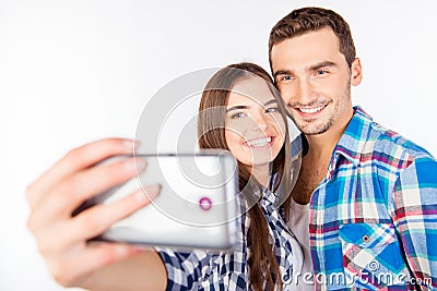 Closeup photo of a cheerful pretty couple in love making selfie Stock Photo