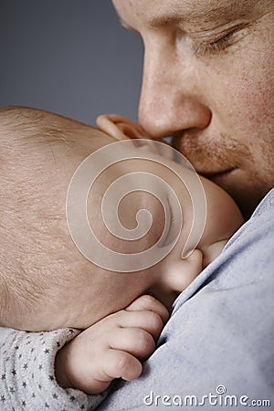 Closeup photo of father kissing newborn baby Stock Photo