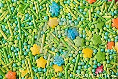 Closeup photo of funny light sugar icing mini stars sticks and balls textured background Stock Photo