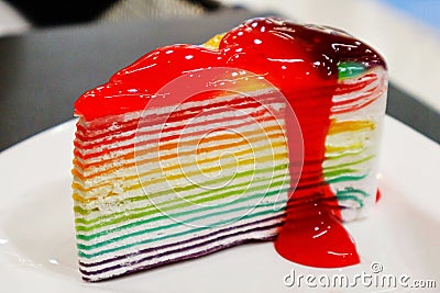 Rainbow Cake with Strawberry Jam on Top Stock Photo