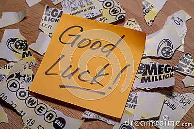 Closeup photo of sticker note on teared up lottery tickets of Power Ball and Mega Millions Editorial Stock Photo