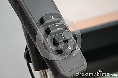 A closeup photo taken on the speed controls panel of a black dark colored standing fan Stock Photo