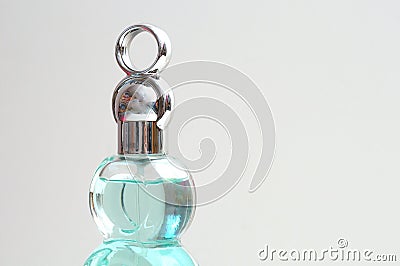 The top lid cover part of a light blue green perfume bottle Stock Photo