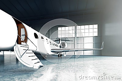 Closeup photo of White Matte Luxury Generic Design Private Jet parking in hangar airport. Concrete floor. Business Stock Photo