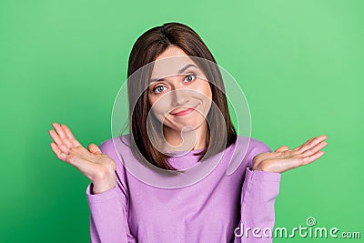 Closeup photo of young attractive lady shrug shoulders dont know answer assistant isolated on green color background Stock Photo